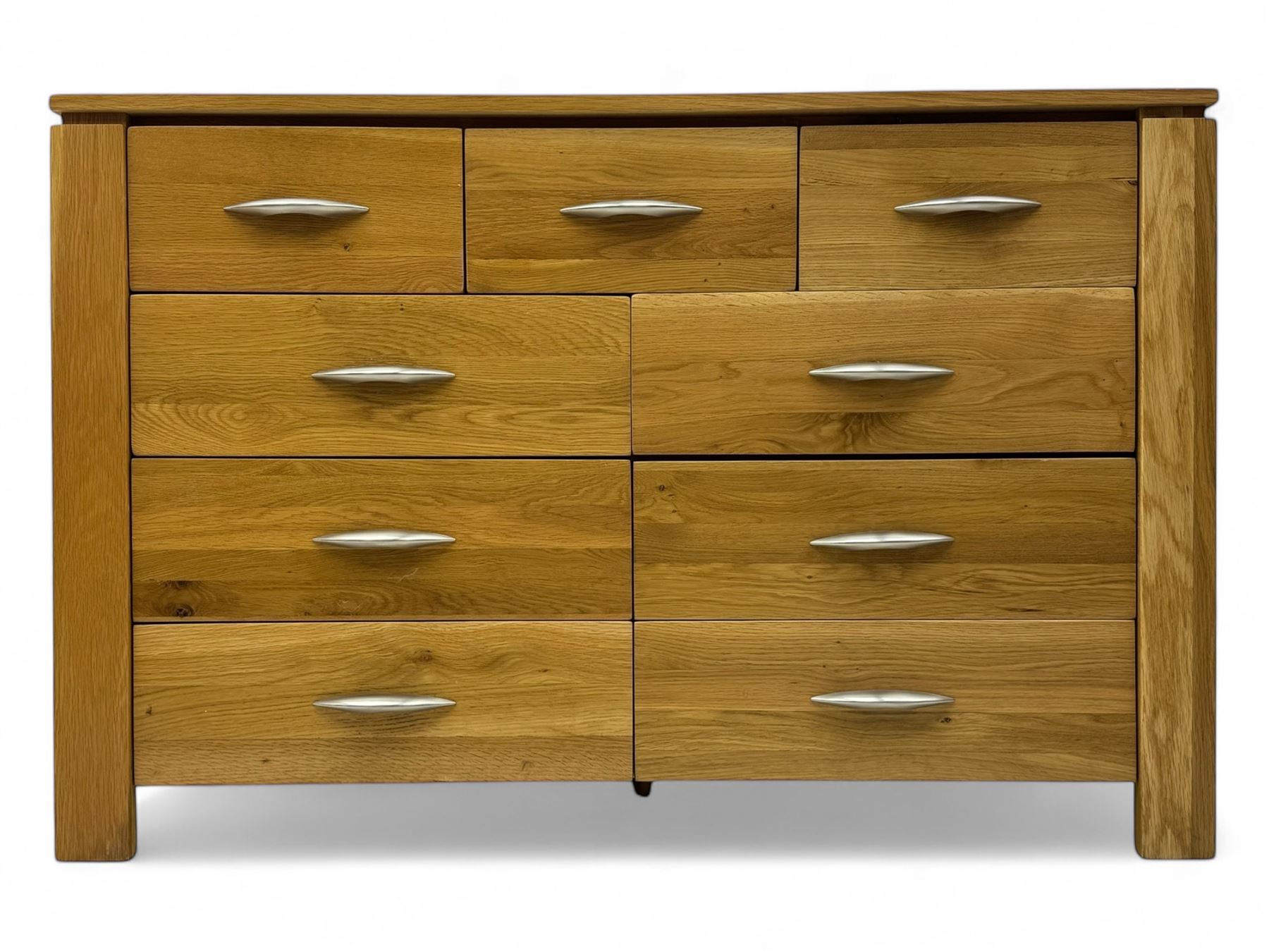 Contemporary light oak sideboard, rectangular top over three short and six long drawers each fitted with chrome handles, on plinth base