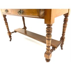 Edwardian satin walnut side table, fitted with two drawers, raised on turned supports and joined by under tier stretcher and castors 