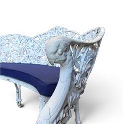 Victorian revival cast two seat garden bench, scrolling lattice back with flower heads, terminating to rams heads arms, curved pierced seat, finished in antique white paint