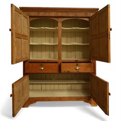 Victorian stripped pine kitchen cupboard, of rectangular form with fluted cornice and top section with two panelled cupboard doors revealing painted shelved interior, middle with two drawers with turned knob handles and brass cup handles, base section with two panelled cupboards, raised on shaped bracket feet 