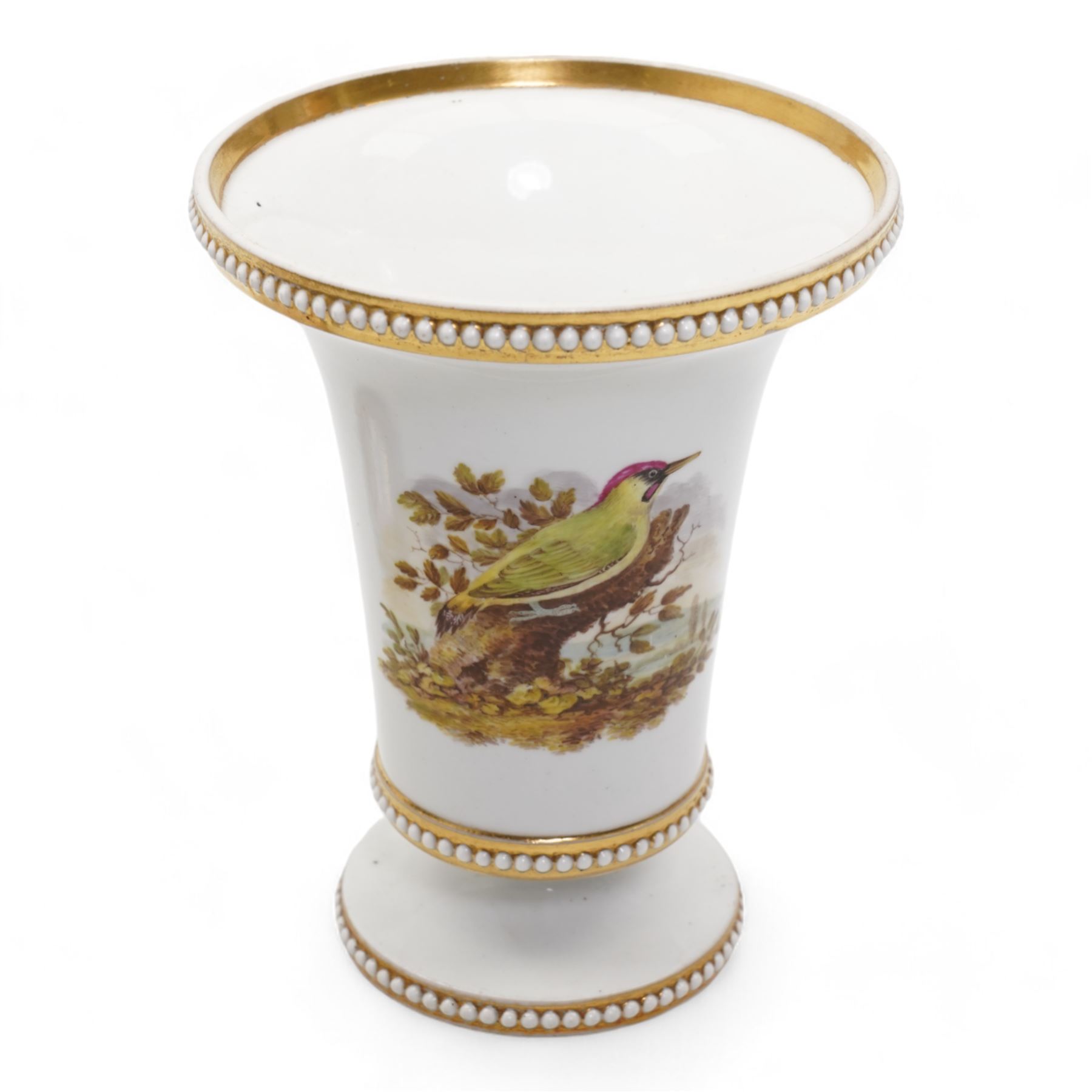 Early 19th century Spode spill vase, of cylindrical form with flared rim, hand painted with a Green Woodpecker perched on a branch, within beaded borders, titled beneath, H16cm, together with a Spode chocolate cup turnover rim stand, decorated in the imari pattern, no. 2630, painted marks beneath, D14cm (2)