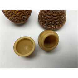 Three 19th century coquilla nut pomanders or flea catchers, each of egg shaped form with carved and pierced decoration and screw threaded join, largest example 6cm