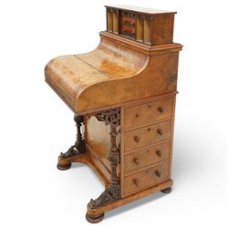 Victorian figured walnut piano top Davenport desk, hidden compartment lifting to reveal small drawers and pigeonholes, the piano lid enclosing drawers and sliding top with hinged leather writing surface, the right-hand side fitted with four drawers, on compressed bun feet 