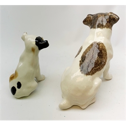 A Winstanley pottery figure modelled as a terrier dog, with inset glass eyes, marked beneath, H28cm, together with another similar smaller example, unmarked, H22cm.