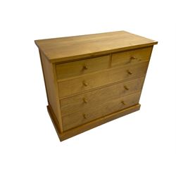 Craftsman made light oak chest, fitted with two short and three long drawers, on plinth base