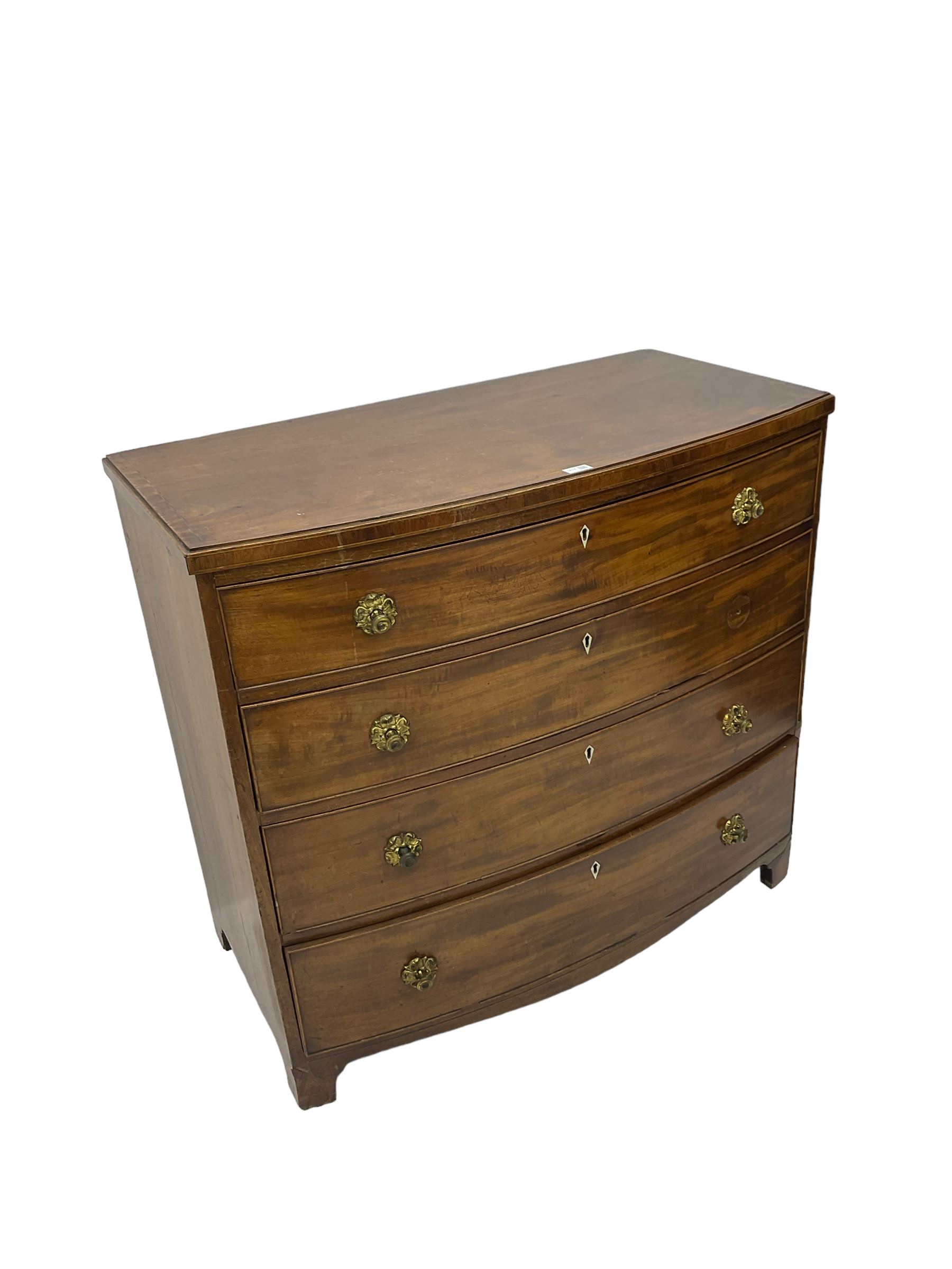 Regency mahogany bow front chest, the top with ebony and satinwood stringing, fitted with four cockbeaded drawers with brass pull handles and bone escutcheons, on bracket feet