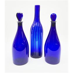 A pair of early 19th century Bristol blue glass decanters with teardrop stoppers, H26cm, together with an early 19th century Bristol blue glass bottle of wrythern twist form, H30cm.