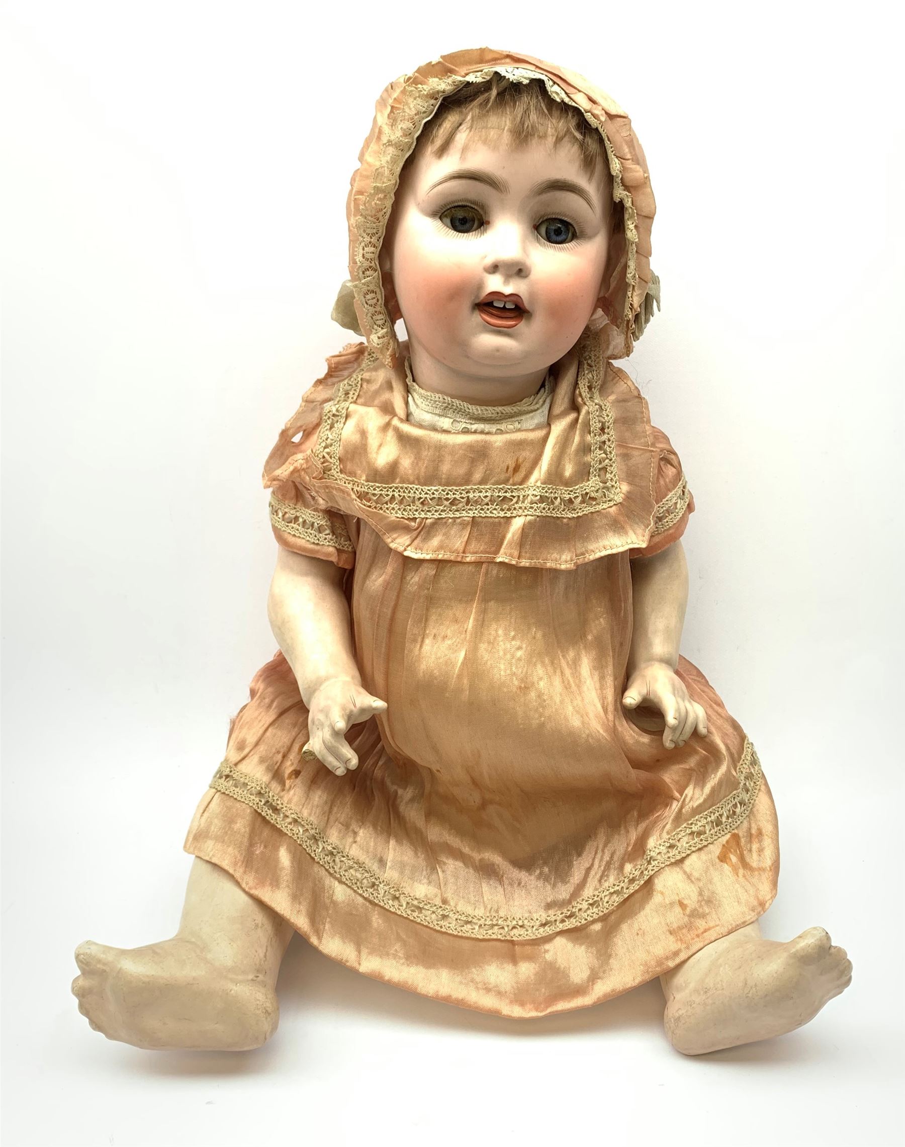 German bisque head doll with applied hair, sleeping eyes and open mouth with teeth and fixed tongue, on composition body with jointed limbs, marked 'P.M. 914 Germany 14' H65cm