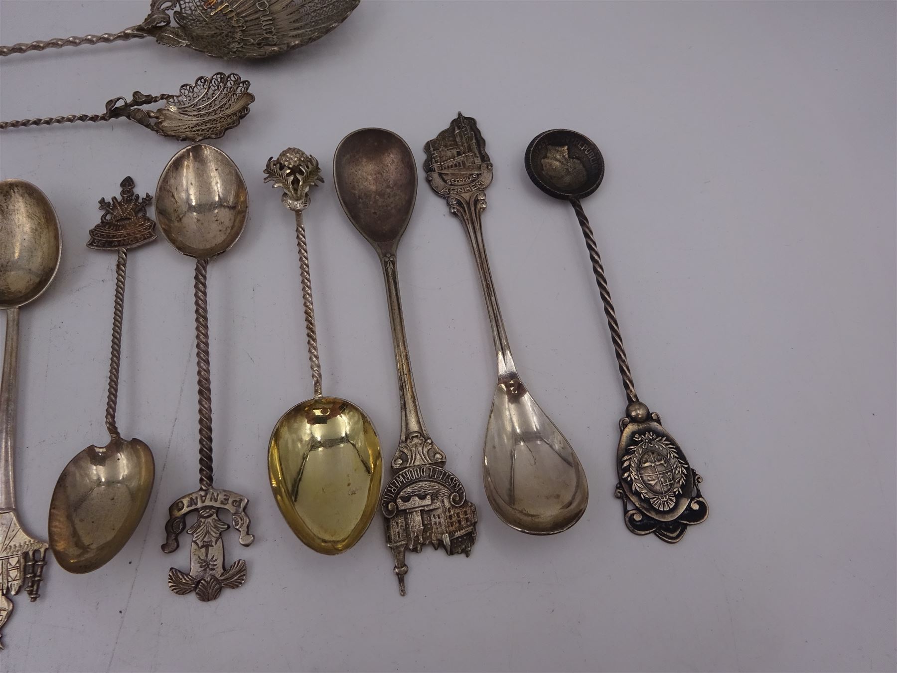 Set of six 1920s silver coffee bean spoons, together with a collection of silver souvenir and similar spoons, including two filigree examples, all tested or hallmarked