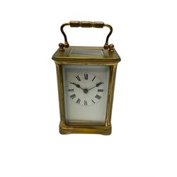 A late 19th century French carriage clock in a Corniche case with a timepiece movement,  white enamel dial , Roman numerals, spade and minute markers, four bevelled glass panels and a rectangular panel to the top, with a cylinder platform escapement.