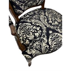 Pair 19th century French walnut Fauteuil open armchairs, the cresting rail carved with shell and flower head motifs, upholstered in foliate and cornucopia patterned fabric, leaf carved cabriole supports and serpentine apron