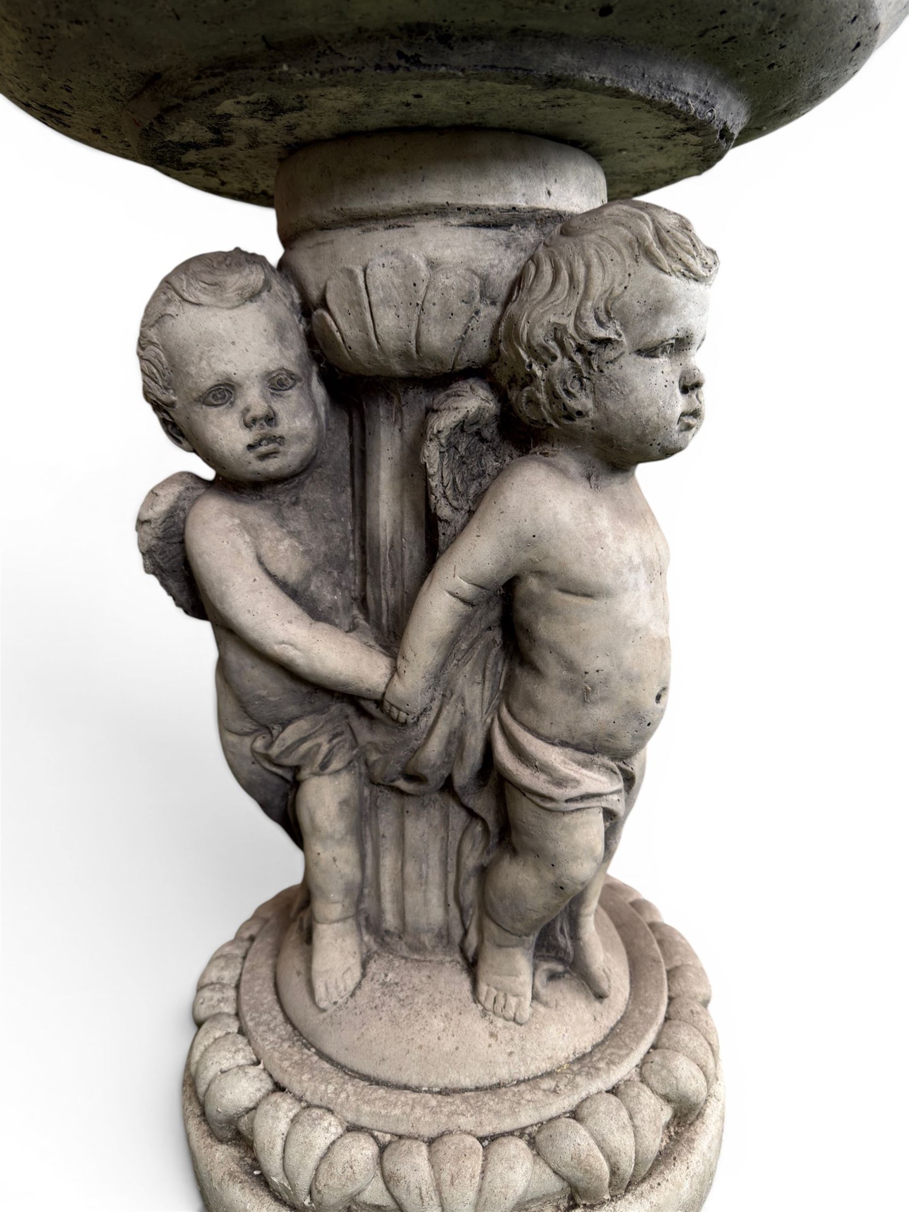Cast stone cherub bird bath, circular removable top raised on three cherubs with ornate detailing