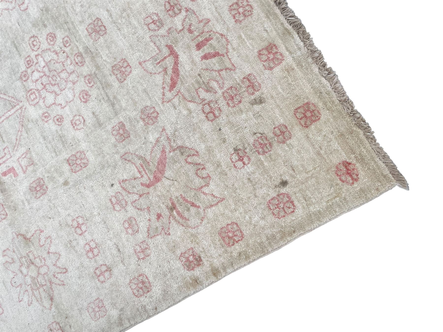Persian design pale ivory ground carpet, decorated with stylised plant and leaf motifs in pale red