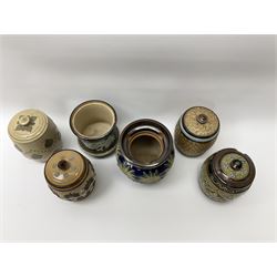 A group of Doulton Lambeth and Royal Doulton tobacco jars, to include examples with relief moulded foliate decoration, each with impressed marks and markers monograms beneath. 