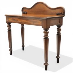 Victorian mahogany side table, raised back with scroll-moulded edge over a rectangular top, raised on turned octagonal supports