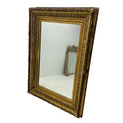Victorian giltwood and gesso wall mirror, the rectangular frame decorated with bay leaf garland and repeating acanthus leaf motifs, moulded inner slips enclosing plain mirror plate 