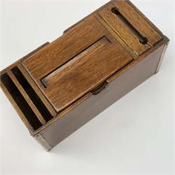 A 1920's silver mounted mahogany cigarette dispenser, with central lift up mechanism also operating a match dispenser, with striker to one end, and two silver cigarette trays and silver corner mounts, hallmarked John Grinsell & Sons, Birmingham 1925, box L16.5cm, trays 6.5cm. 