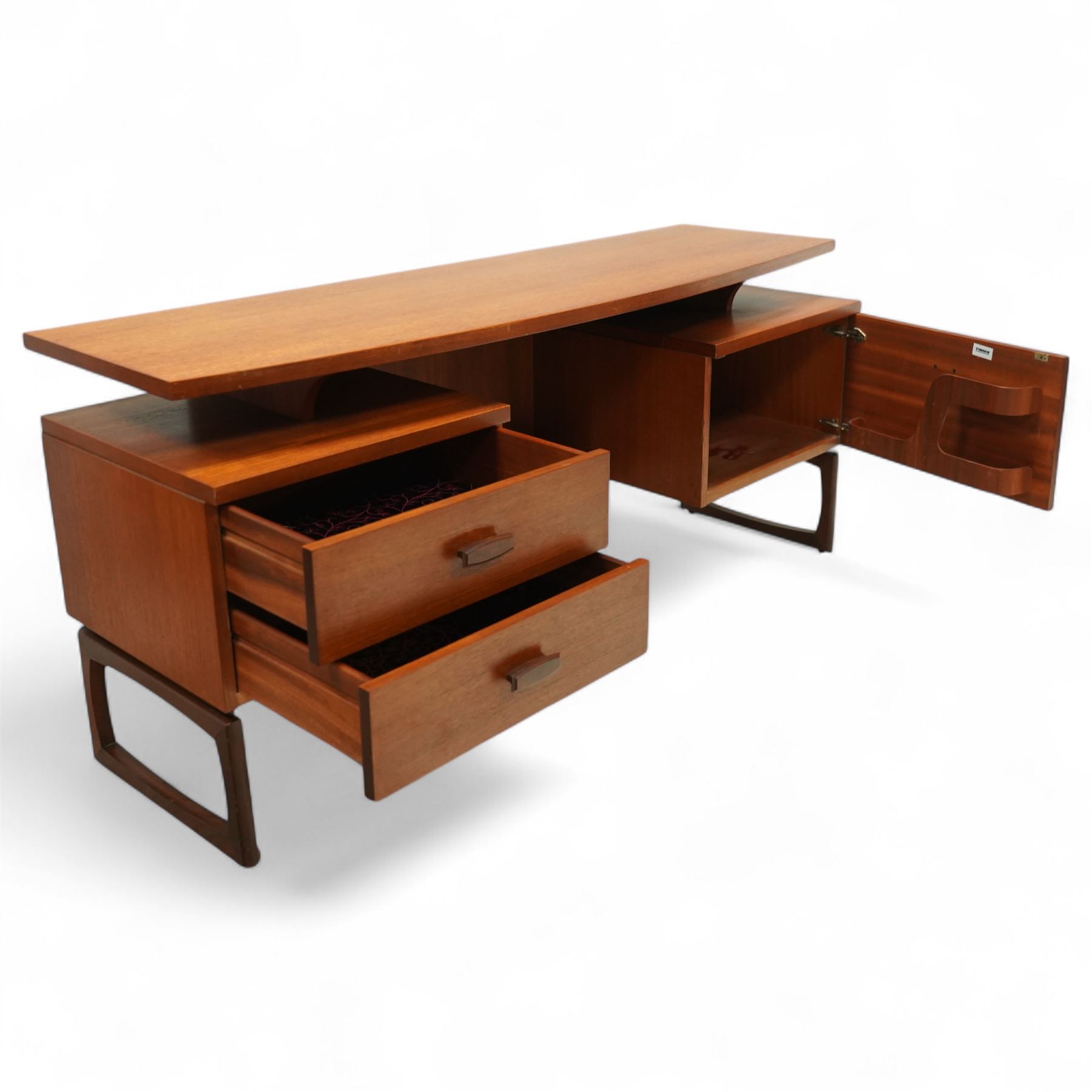 R Bennett for G Plan - mid-20th century teak 'Quadrille' desk or dressing table,  shaped platform rectangular top above rectilinear open base above four drawers with sculpted handles, on rectangular frame supports 