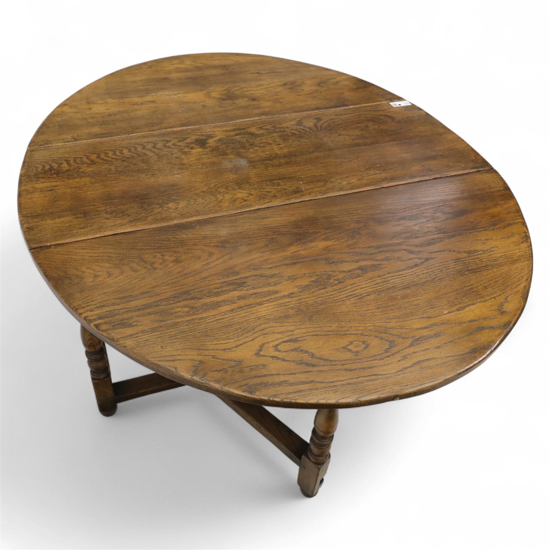 17th century design oak gateleg dining table, oval drop-leaf top on baluster turned supports, twin swinging gate legs united by peripheral stretchers (Extends to 149cm)