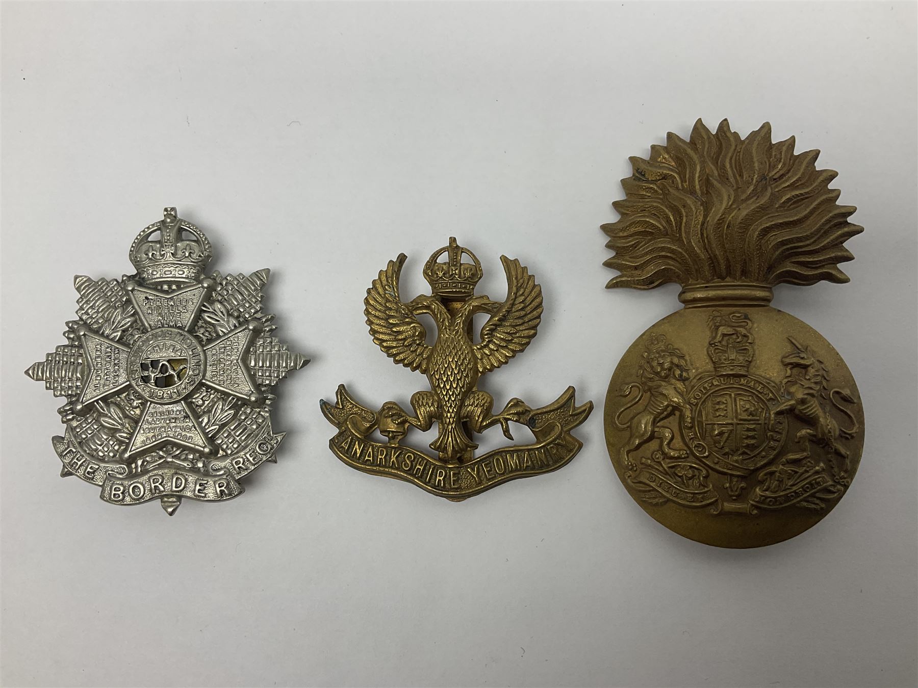 Fifteen Scottish Glengarry and other metal military badges including Argyll & Sutherland, Royal Glasgow Yeomanry, Cameronians, Lanarkshire Yeomanry, Kings Scottish Own Borderers, Highland Light Infantry, Border Regiment, Lowland Regiment, Lothians & Border Horse Yeomanry, Ayrshire Earl of Carricks Own Yeomanry etc