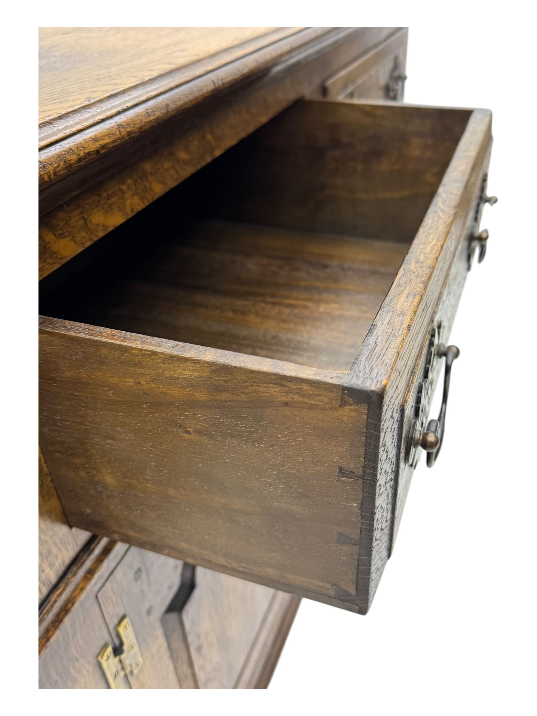 Early 20th century Jacobean design oak dresser sideboard, rectangular top with moulded edge over two baize-lined drawers with pierced handles, above two fielded panel cupboard doors, on stile supports