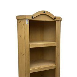 Pine media or television cabinet, enclosed by single glazed door (W56cm, H82cm, D43cm); pine corner cupboard, three shelves over single cupboard (W76cm, H188cm); pine two-tier plate rack with shaped frieze and uprights (W113cm, H107cm)