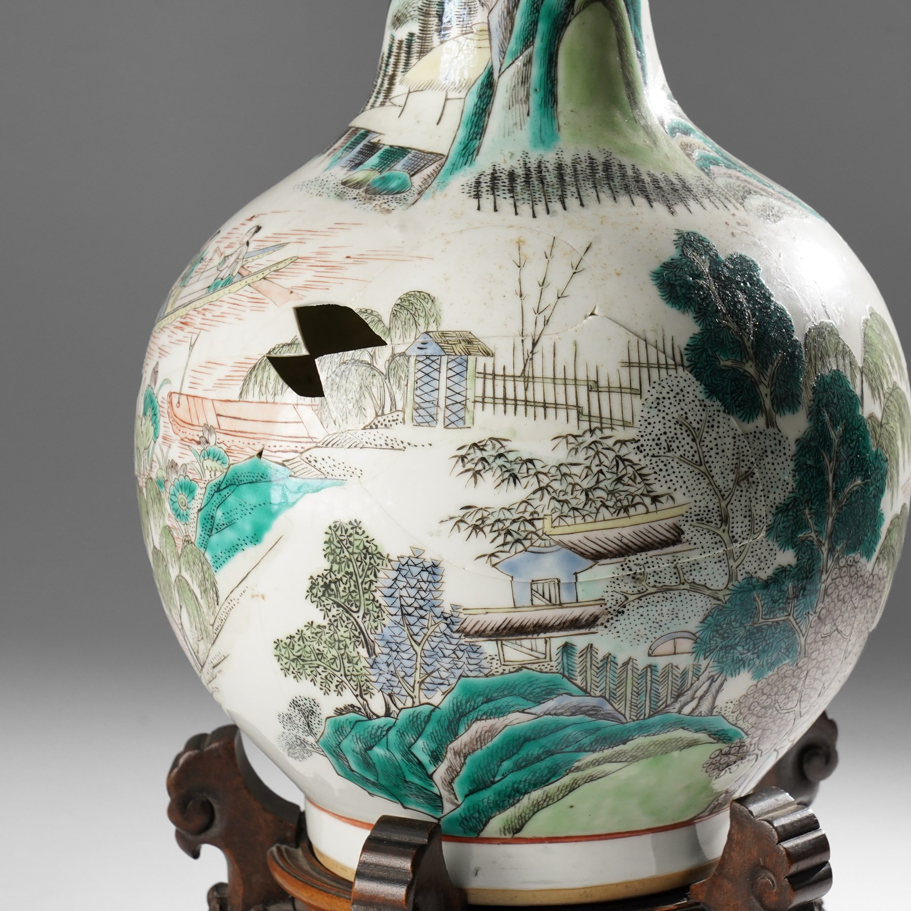 Chinese Kangxi period famille verte vase, the body finely painted with a continuous narrative scene of figures inside and out of a pavilion complex, beside a river, rocks and trees, character mark to base, raised upon a hardwood stand, overall H47cm