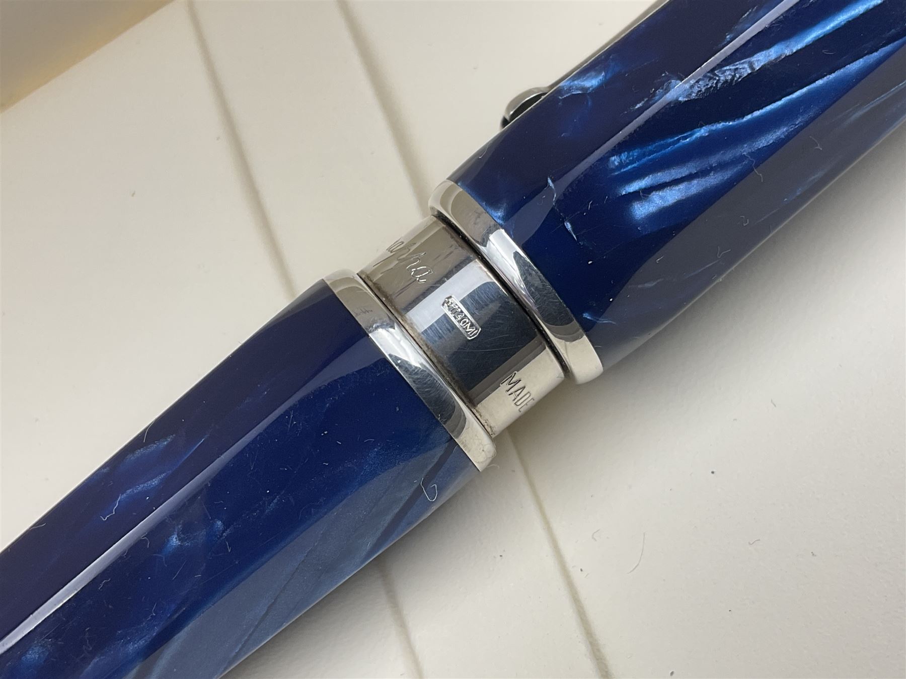 Montegrappa Emblema ball pen, the blue pearl marbled barrel of octagonal form with silver mounts and terminal with 1912 emblem, stamped 925 and clip with roller, in box, L13.5cm
