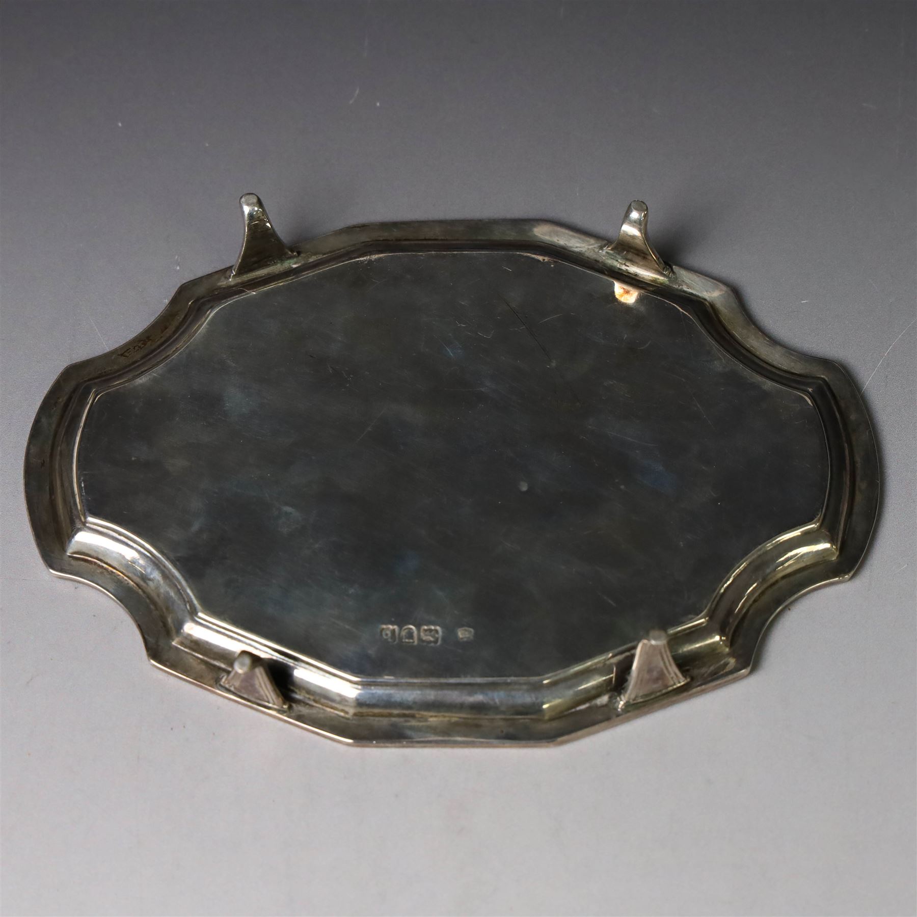 Victorian silver teapot stand, with chippendale style rim and engraved crest to centre, upon four pad feet, hallmarked Thomas Bradbury & Sons, London 1897, W18cm