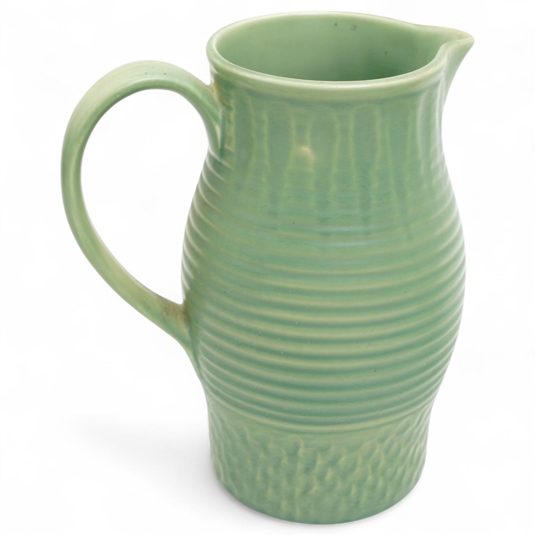 Susie Cooper pottery jug, the green glazed body with ring turned and dimpled decoration, inscribed 'Susie Cooper, England' to base, H23cm; together with two similar art deco pottery jugs with similar decoration, by Price Brothers and Ditmar Urbach, larger H21cm (3)