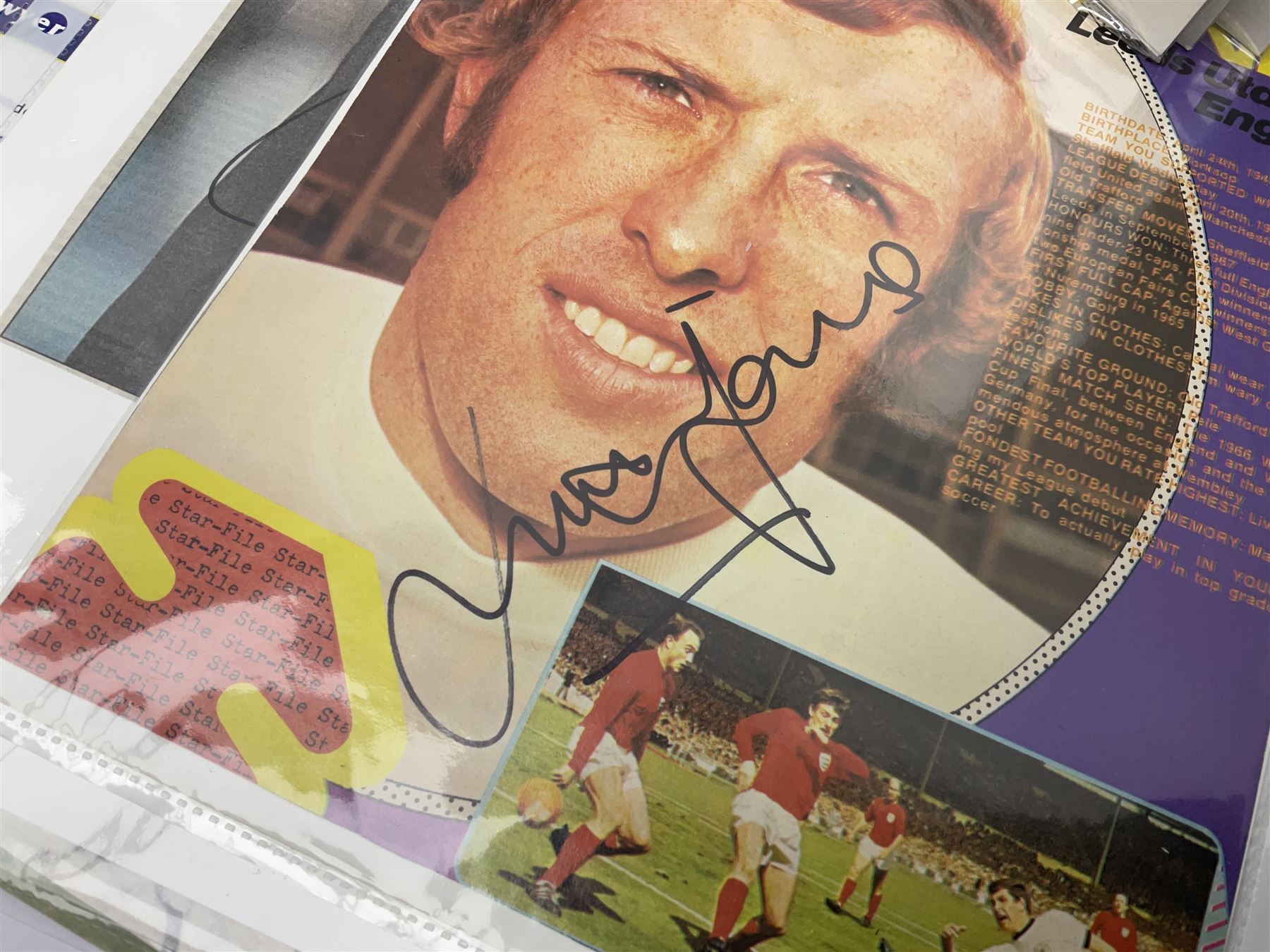 Collection of approximately 200 Leeds United related autographs, predominantly signed newspaper cuttings, contained within ring binder, together with a number of loose examples