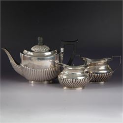 Victorian silver bachelors teapot, of part fluted oval form with ebonised wooden handle an...