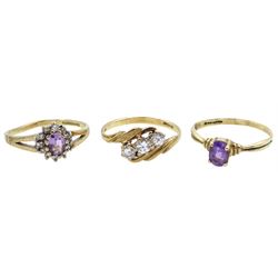 Gold amethyst and cubic zirconia cluster ring, gold three stone cubic zirconia crossover ring and a gold single stone amethyst ring, all hallmarked 9ct 