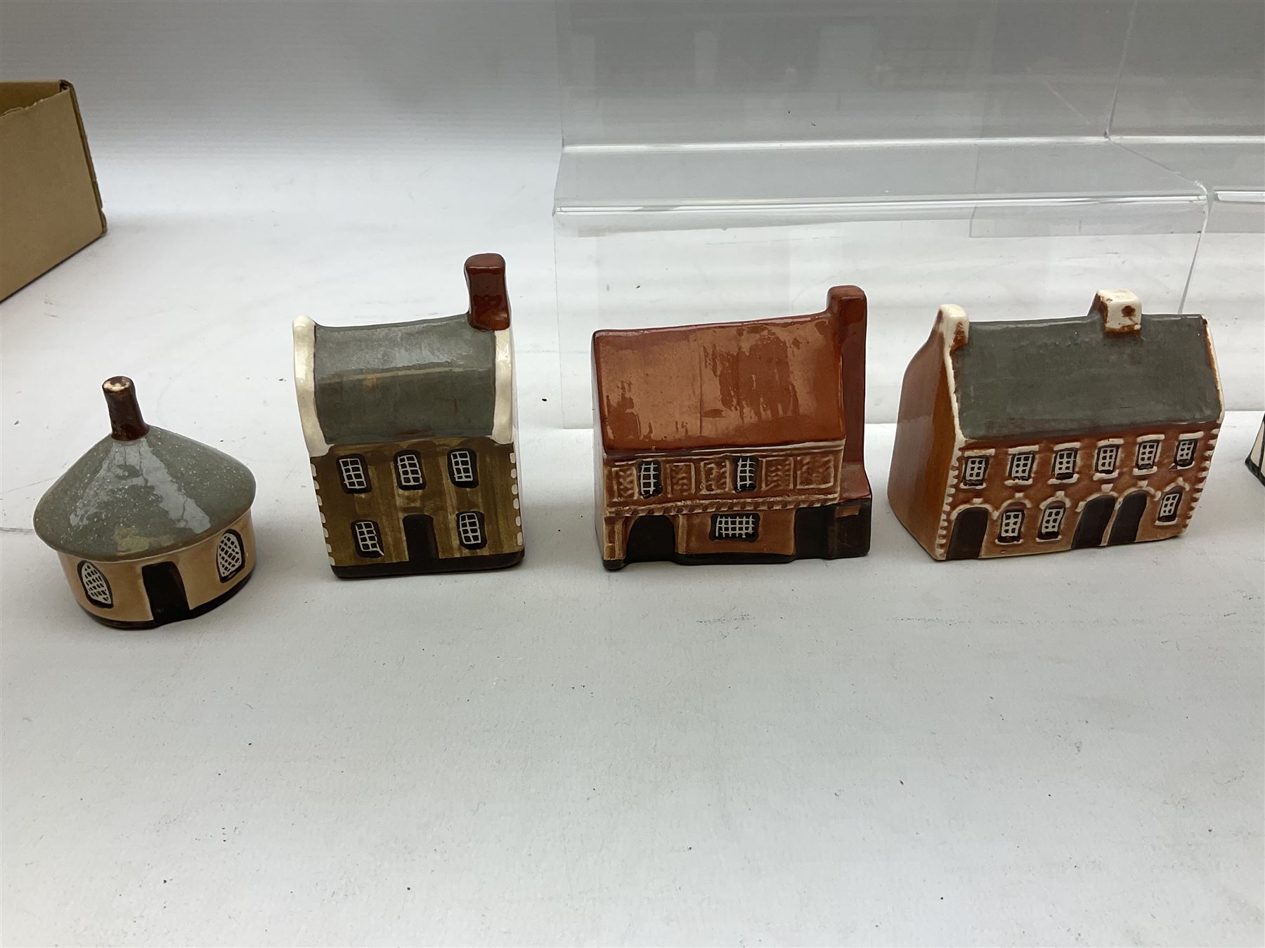 Twenty studio pottery figures of houses and cottages, comprising seventeen Mudlen End Studio Felsham Suffolk examples and two John Putman's Heritage Houses examples