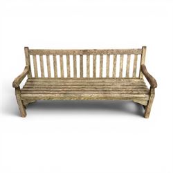 Teak garden bench with slatted back and seat raised on square supports