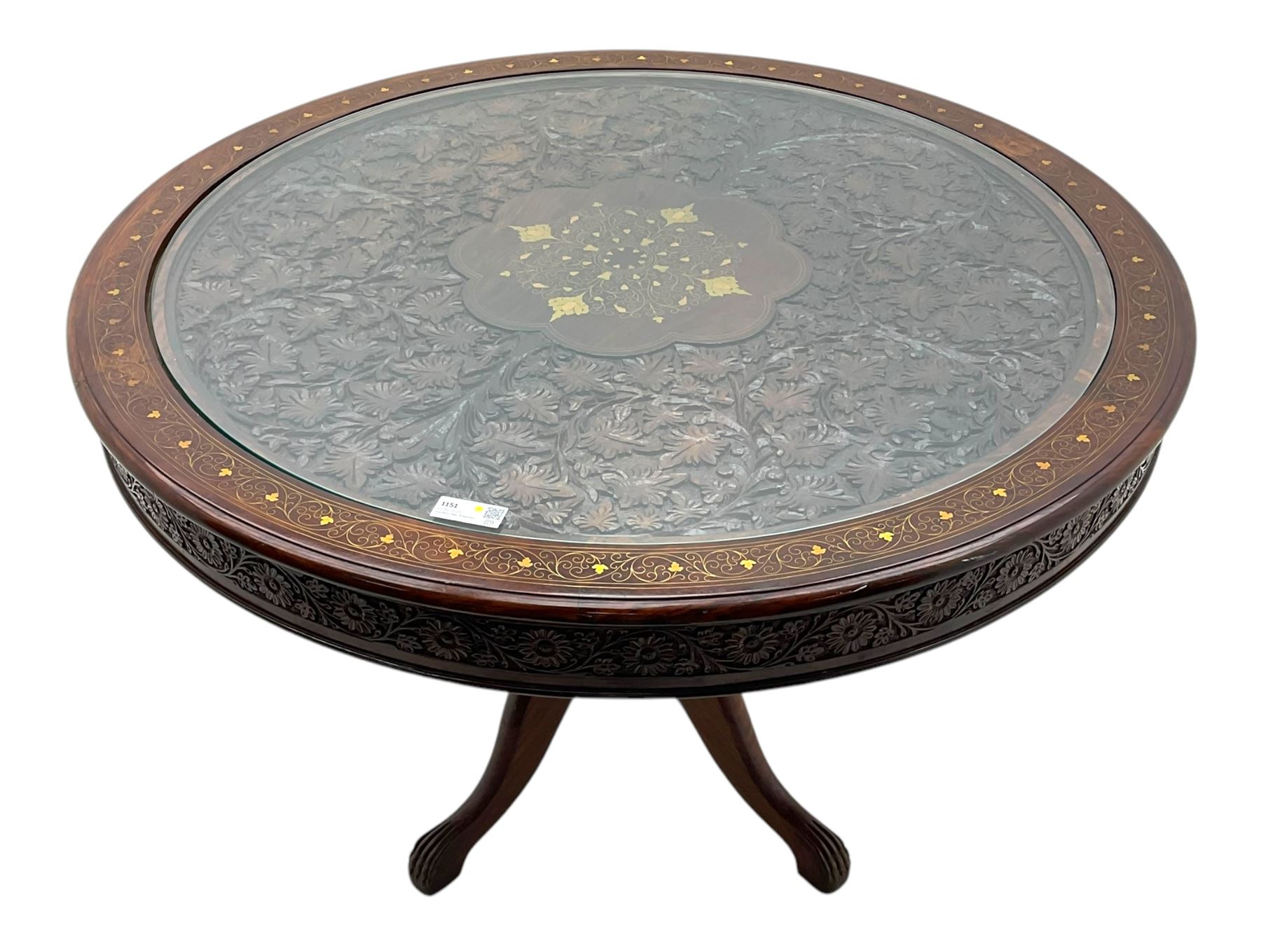 Pakistan carved hardwood brass inlaid circular dining table, and four rail back chairs with saddle seats