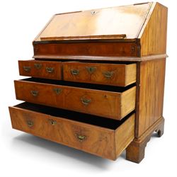 18th century figured walnut bureau, the sloped fall-front enclosing fitted interior with sliding base, pigeon-holes and correspondence drawers with shaped facias, over two short and two long feather-banded drawers with pressed brass handle plates, on bracket feet
