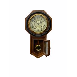 Contemporary spring driven wall clock striking the hours on a gong, case with a wooden octagonal dial surround and two piece creme dial with Arabic numerals, steel spade hands, brass effect pendulum bob visible through case door, dial inscribed 