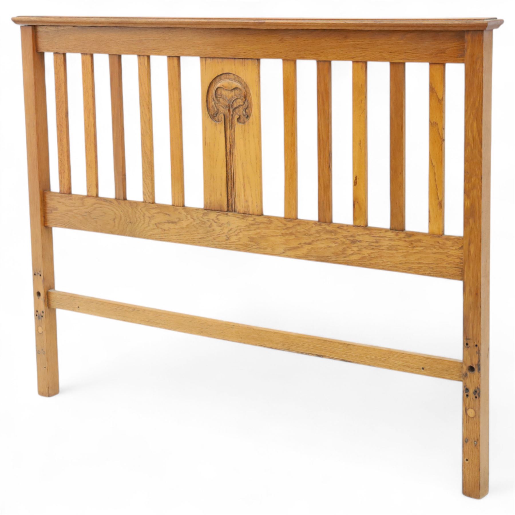 Art Nouveau oak double bed headboard, rectangular form with vertical slats centred by a carved stylised floral roundel
