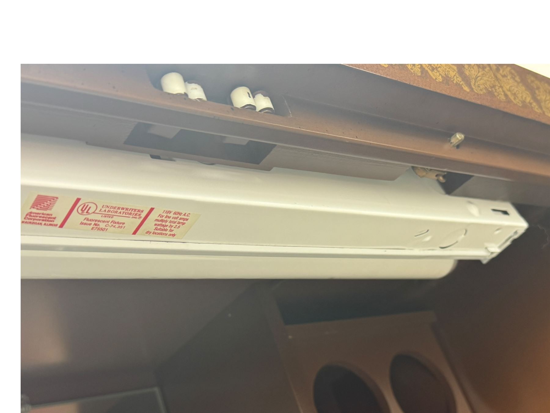 Chinese brown lacquered cocktail cabinet, decorated with gilt scenes of a traditional landscape with figures, pagodas, and mountainous scenery, double doors opening to reveal fitted interior with mirrored back, wine rack, shelves and cupboard, raised on square supports