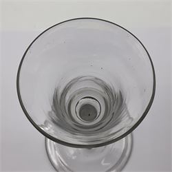 Three 18th century wine glasses comprising a plain stemmed glass with bell shaped bowl and conical folded foot H16cm, another plain stemmed glass with ogee bowl and folded foot and a Continental glass with gilt faceted bowl, decorated with male figure within a landscape, on a clear Silesian seven sided cut stem (3)