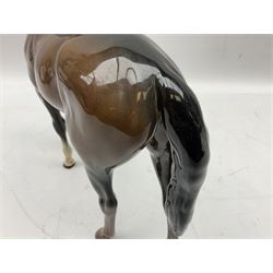 Three Beswick figures, comprising Large Hunter model no.1734,  Small Stallion model no.1992, foal model no.915 and Royal Doulton foal