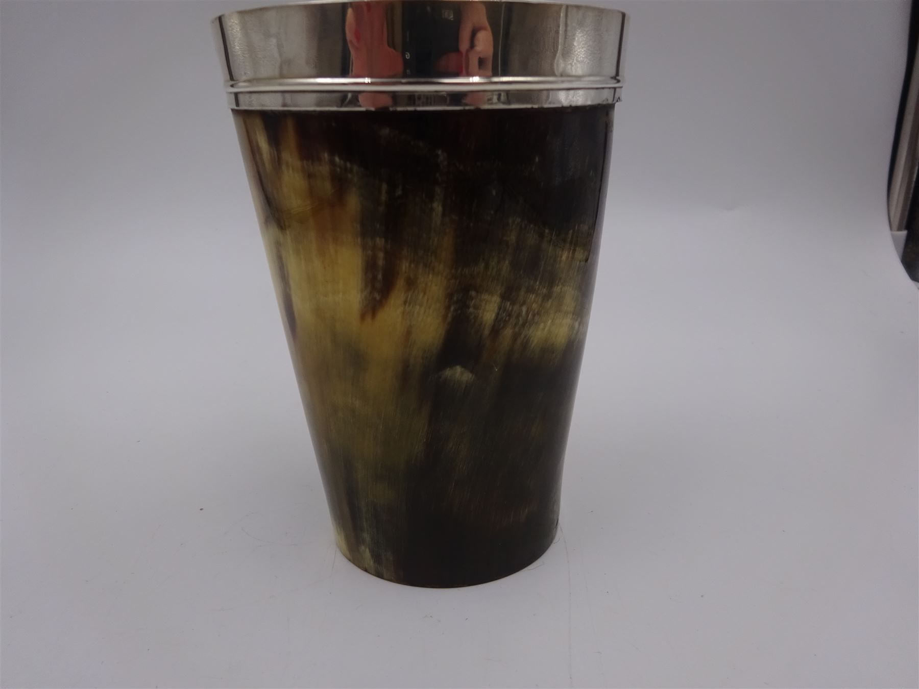 George III silver mounted horn cup, of tapering circular form, with polished exterior, the silver mounted collar hallmarked London 1808, no visible assay or makers mark, H13.5cm