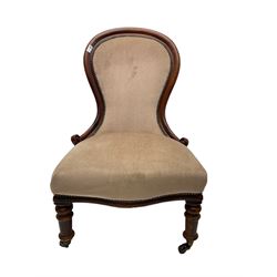 Victorian mahogany spoon back nursing chair, serpentine seat, on turned front supports with brass and ceramic castors