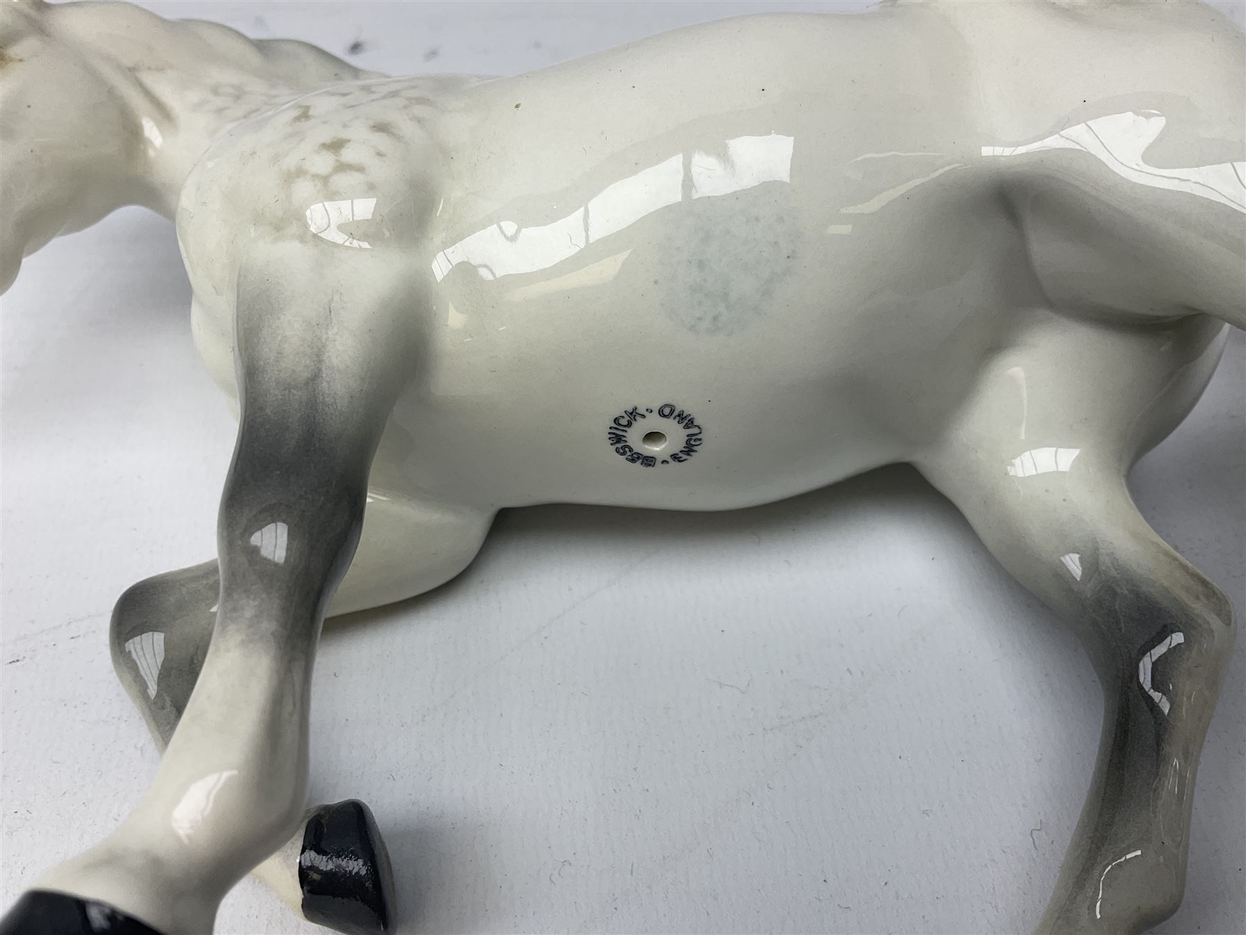 Collection of Beswick horses, including grey horse no.701, palomino foal no 836, grey stocky jogging mare no.855 etc, together two Royal Doulton horses, (8)