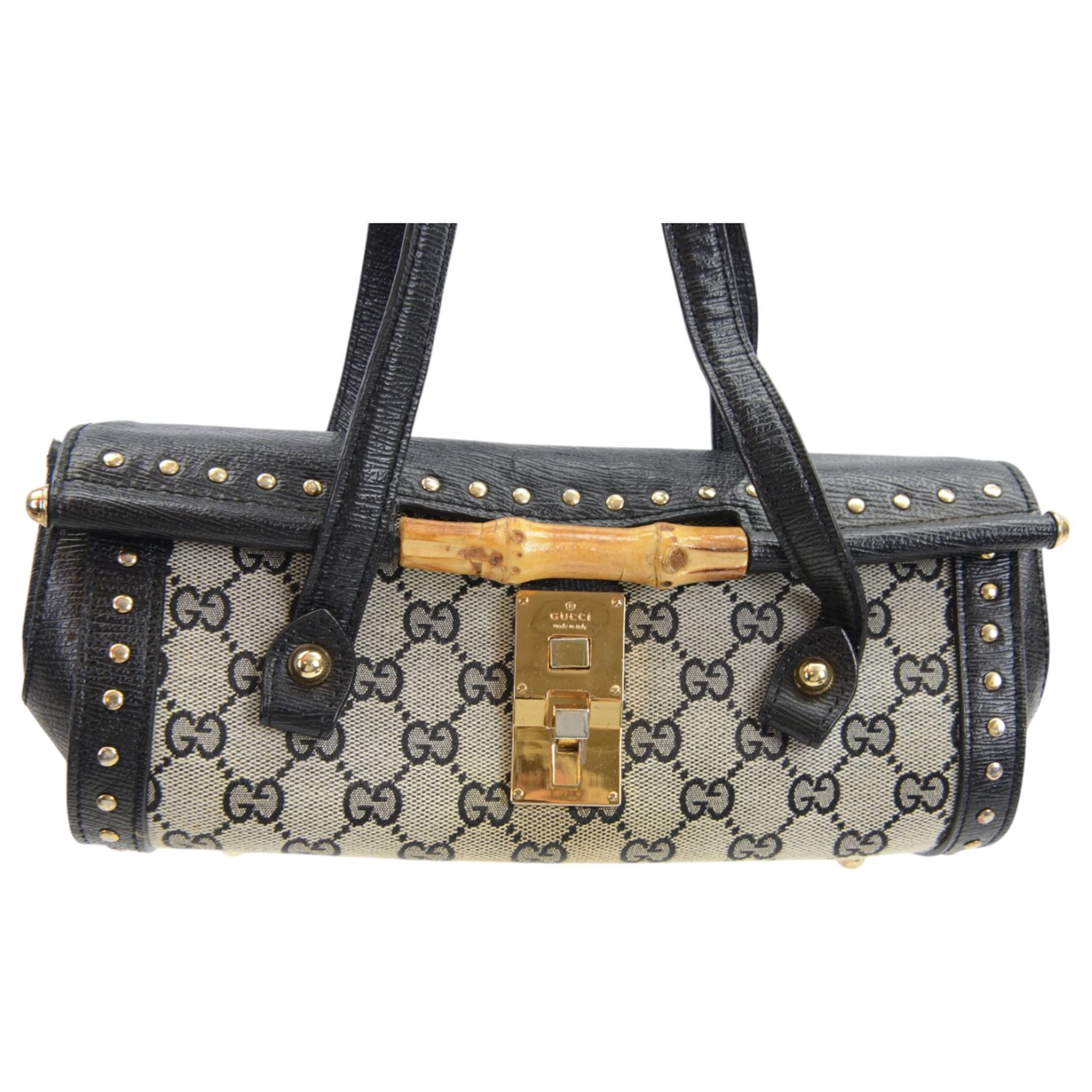 Gucci 'Bamboo Bullet' shoulder handbag, the canvas body with repetitive GG logo design and black studded leather border, with gold tone clasp impressed Gucci, and bamboo handle, with interior zip pocket, serial no. 910998 9019 impressed to interior leather, with Gucci satin dust bag, H14cm, W20cm