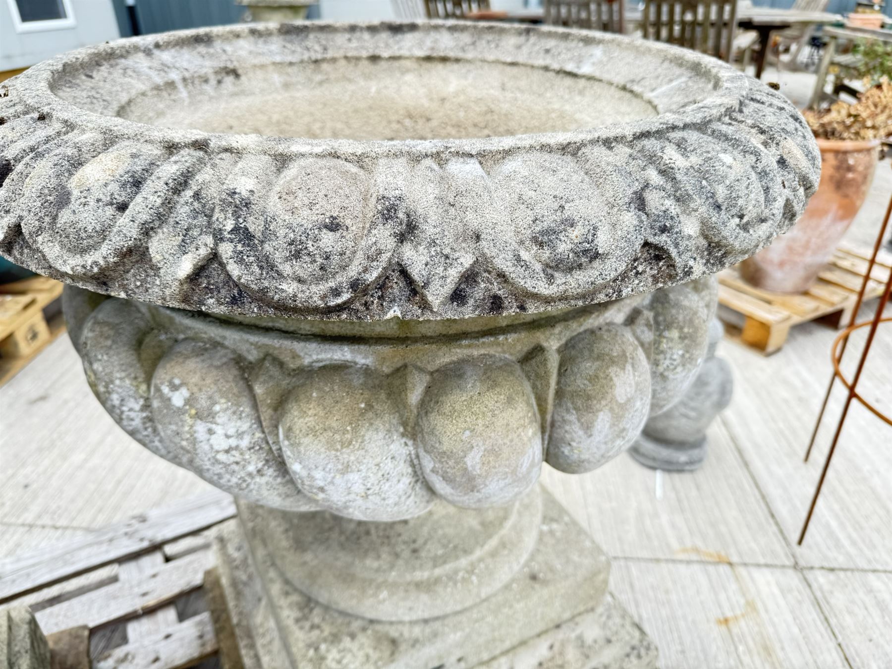 Pair of large weathered Country House Haddonstone garden urns, acanthus carved rim above gadrooned bowl, beaded detailing to the neck, raised on stepped double plinth base
