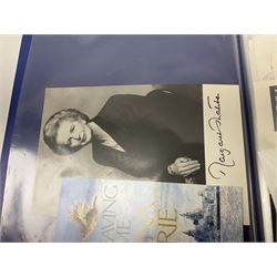 Two folders of over fifty photographs, cards, compliment slips etc of actors, actresses, celebrities, politicians, sports personalities etc, all bearing signatures, including David Frost, Lloyd Grosman, John Suchet, Julia Somerville and othe GMTV presenters, Carol Vorderman, Jackie Collins, Rolf Harris, Timothy Dalton, Pete Postlethwaite, Magnus magnusson, John Major, Kate Moss, Uri Geller, David Beckham, Peter Alliss, Sharon Davies, Kevin Keegan etc