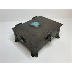 Arts and Crafts copper box, the lid decorated with stylised riveted hinges and inset with Ruskin type ceramic turquoise heart-shaped cabochon, the mount etched M.B 1913, and further cabochon roundel to each side panel, including one inset to the clasp acting as the knob to the locking mechanism, marked RS Douglas 1913 beneath, W16.5cm H7cm D15cm