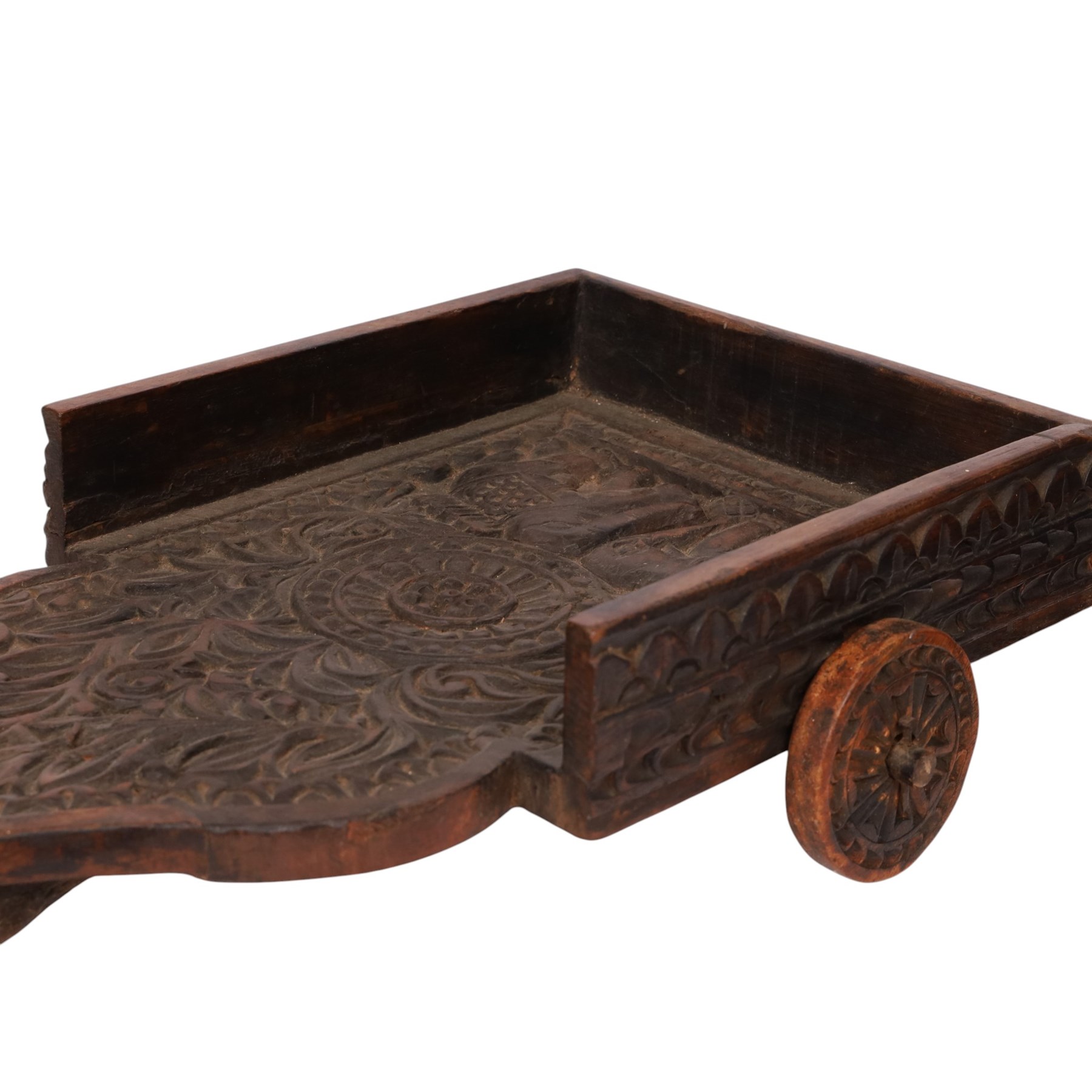Indian carved wooden tray on wheels, the front carved as a horses head, the cart with foliate details, H28cm